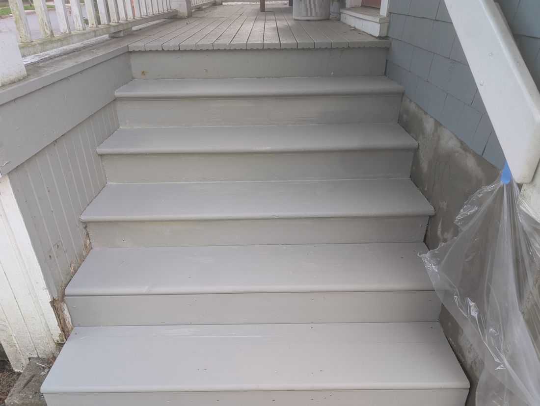 The same exterior steps with every tread and riser painted in an even grey finish.