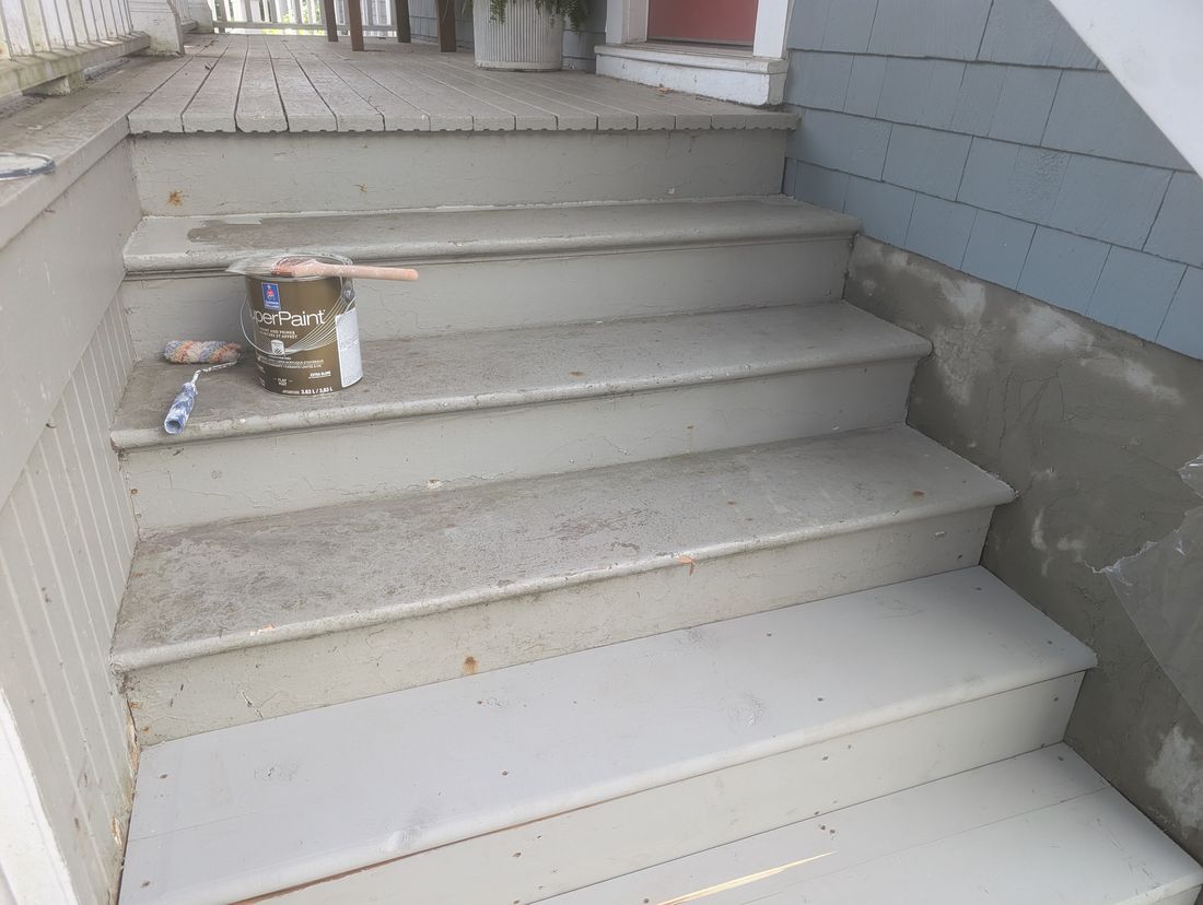 Exterior wooden steps part way through painting, with bare and weathered treads.